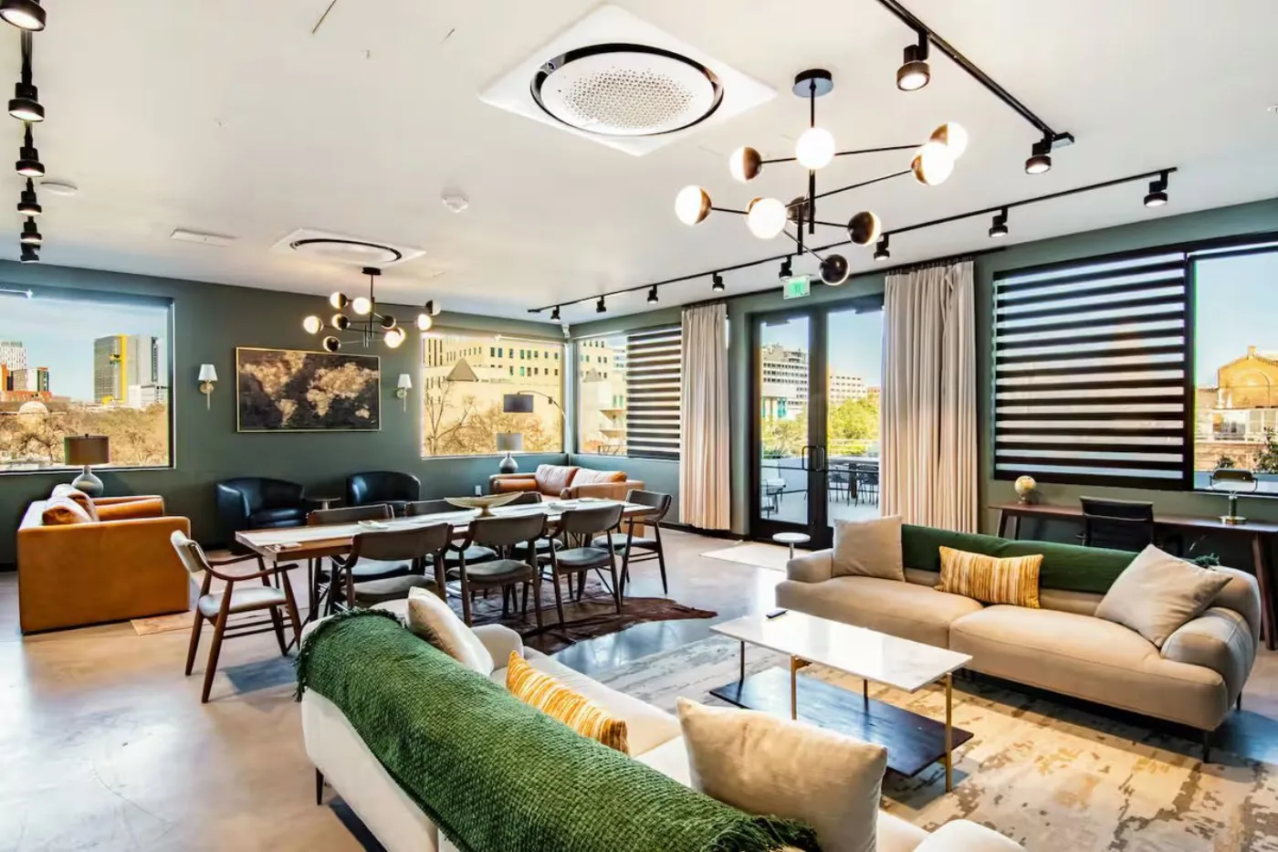 Capitol resident lounge with sofas, dining table and city views