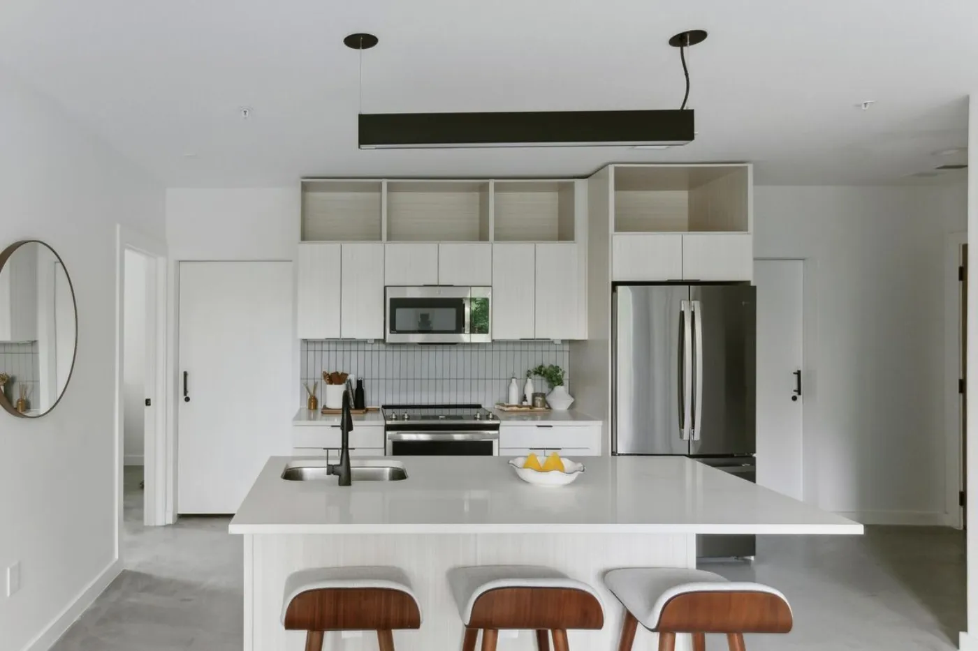 Capitol apartment kitchen with island, quartz counters and stainless appliances