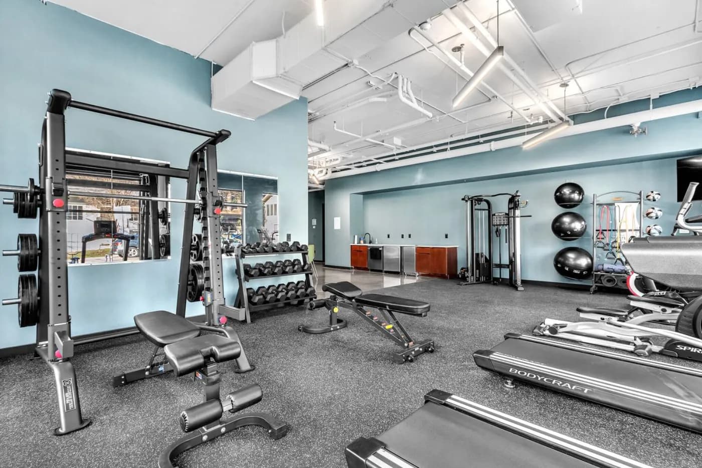Capitol fitness center with squat rack, free weights and cardio machines