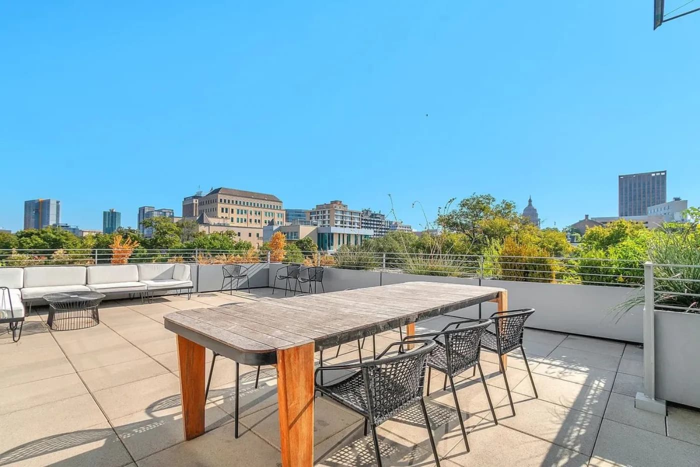 Capitol rooftop terrace with dining table and downtown Austin skyline