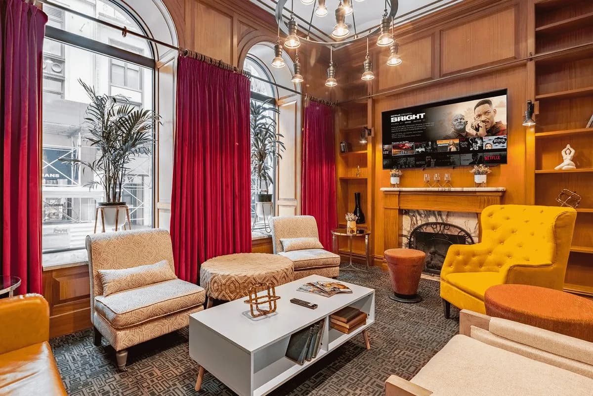 Mansfield wood-paneled lounge with fireplace and TV