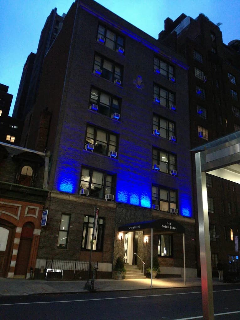 Seton building exterior at dusk, lit blue